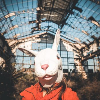 rabbit mask woman red coat winter desolate landscape