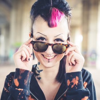 young beautiful punk dark girl in urban landscape