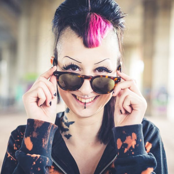 young beautiful punk dark girl in urban landscape